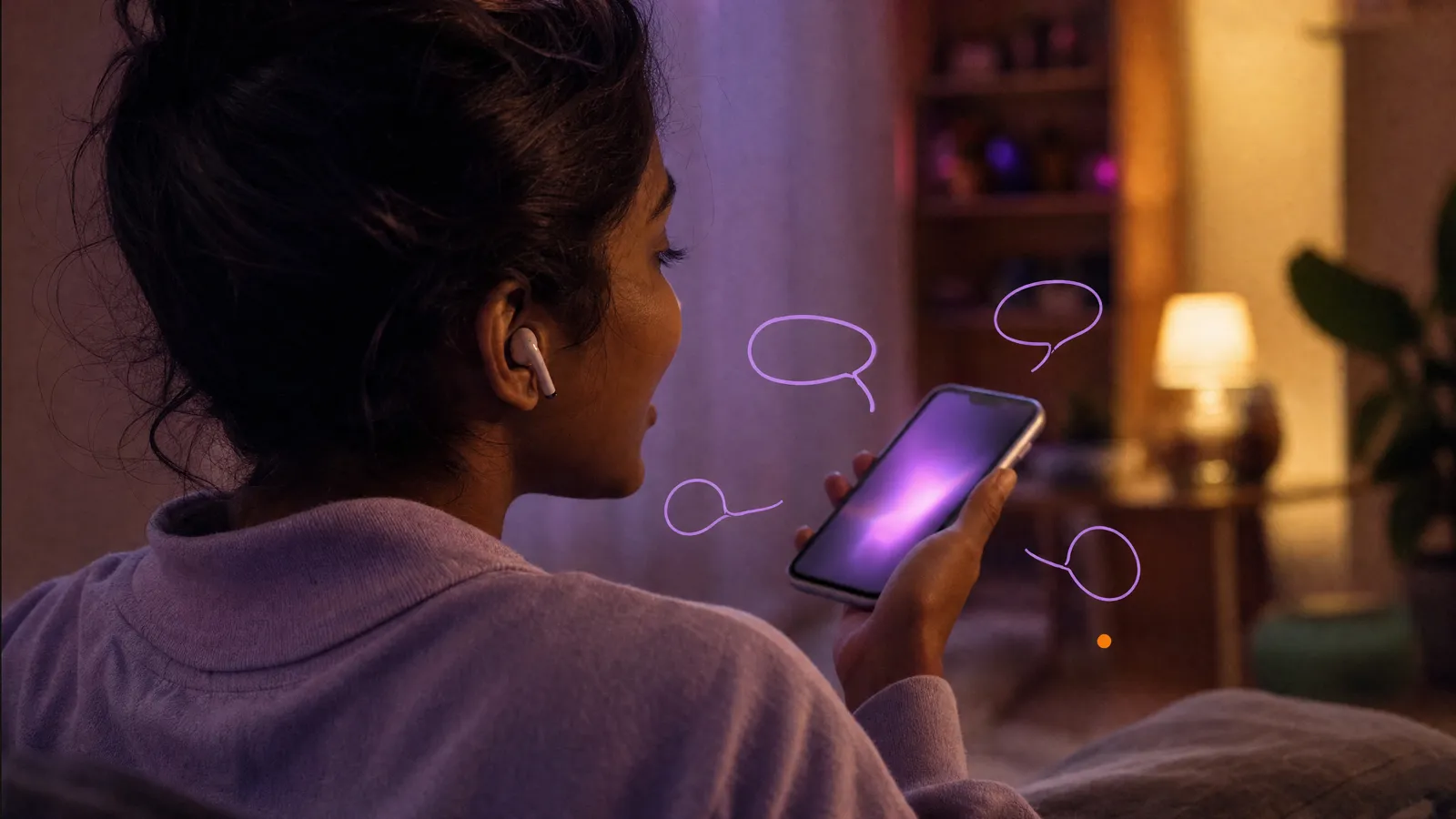 Over the shoulder of a woman wearing earbuds as she talks to her softly glowing phone at home, doodled speech bubbles around the screen